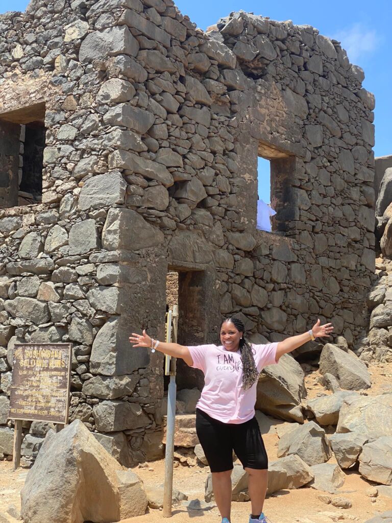 Taking a picture in front of the Bushiribana gold Mine in Aruba